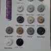 A collection of various silicone sealant colours displayed in circular containers, including shades like translucent, white, off white, misty grey, light grey, blue stone, almond ivory, travertine beige grey, walnut, pewter, monument matt white and matt black.